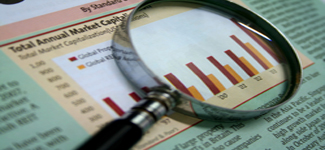 Picture of magnifying glass with sample charts of capital projections