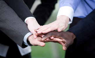 People holding hand in unity conveying the message that integrity is apart of their business.